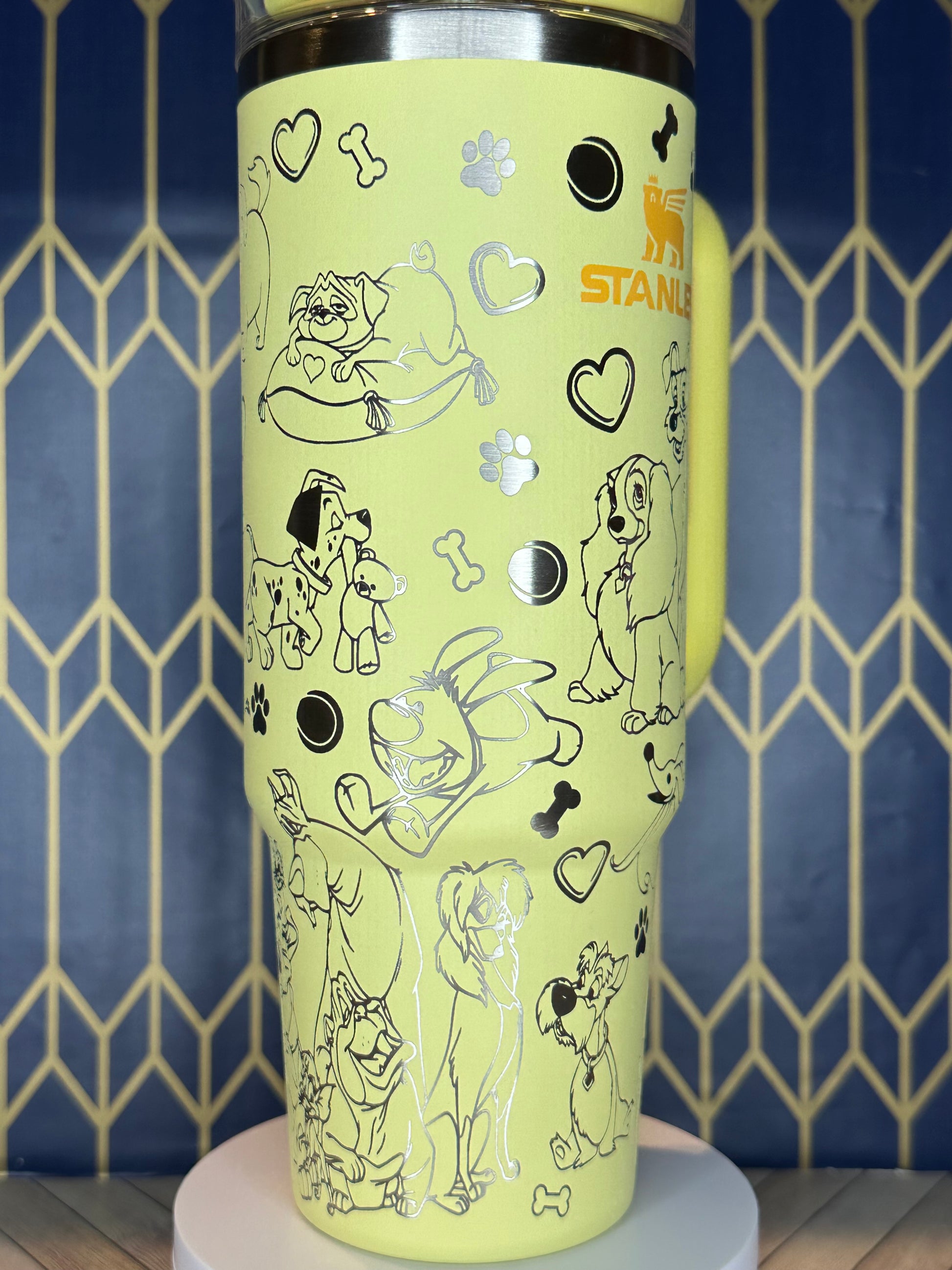 a close up of a yellow cup with drawings on it