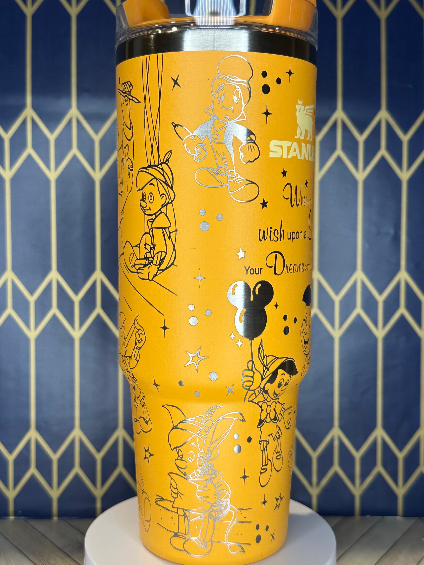 a close up of a yellow cup on a wall