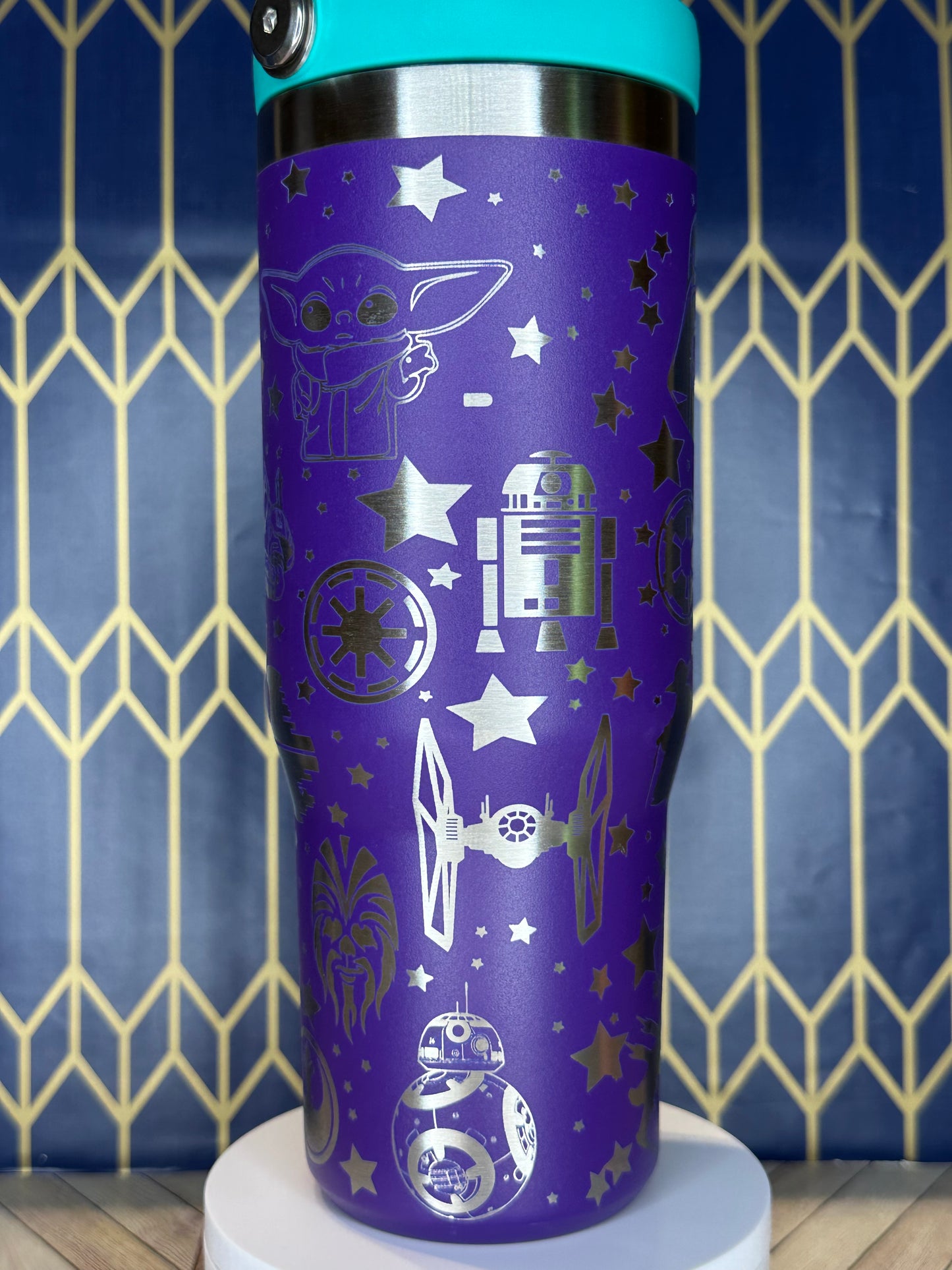 a close up of a purple cup on a wall