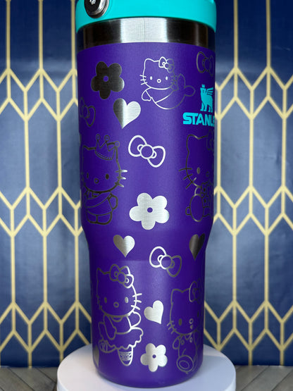 a purple and blue cup with hello kitty designs on it