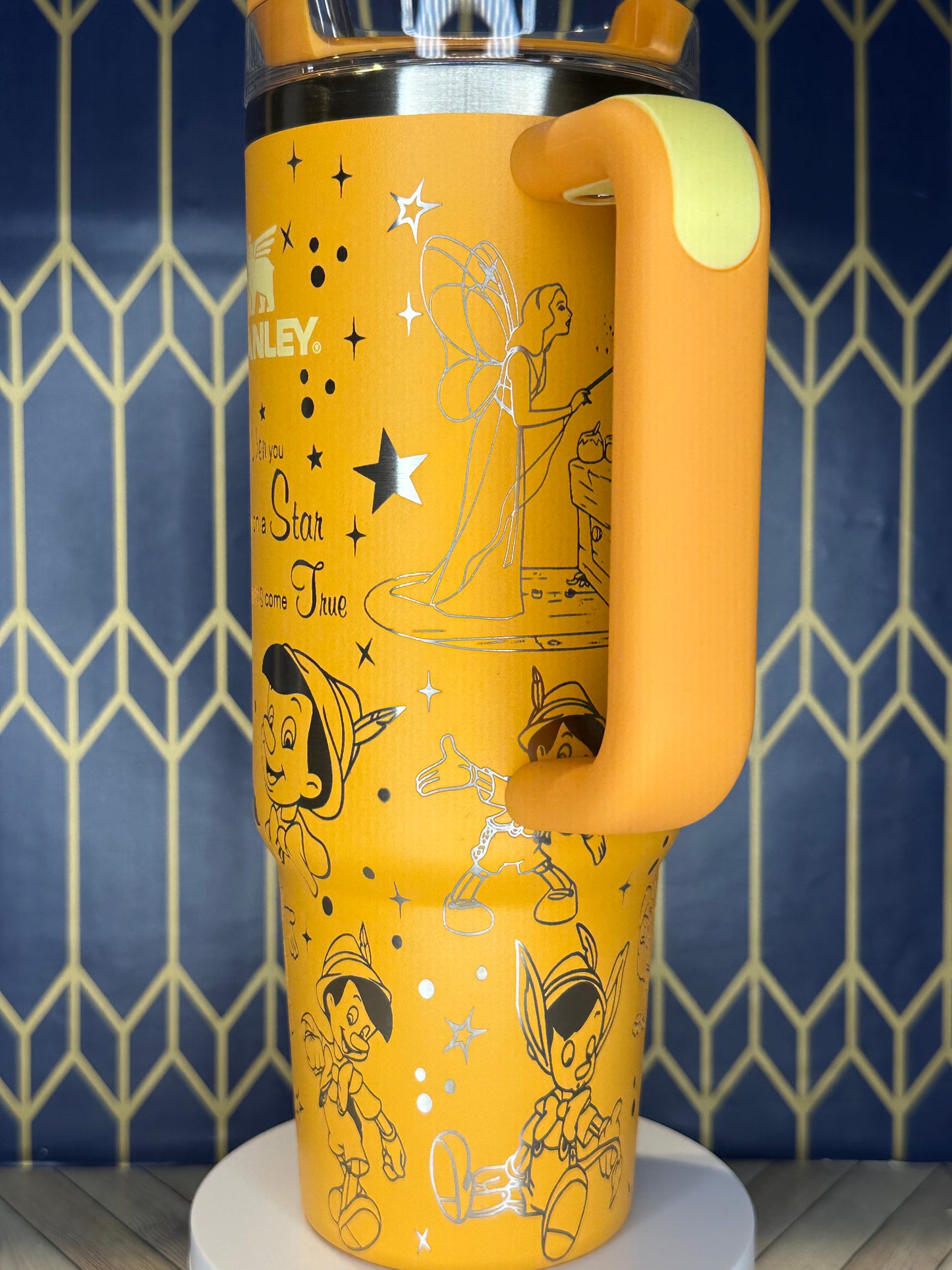 a close up of a yellow cup on a wall