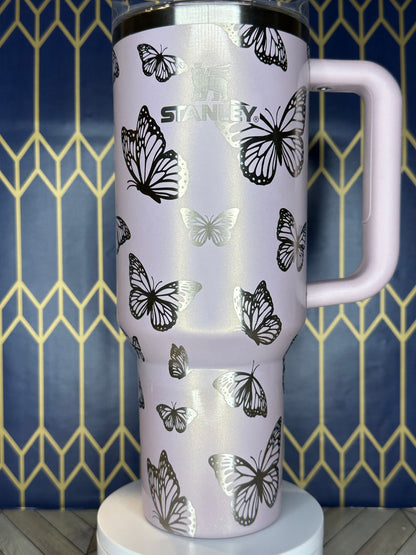 a close up of a cup with a butterfly pattern on it