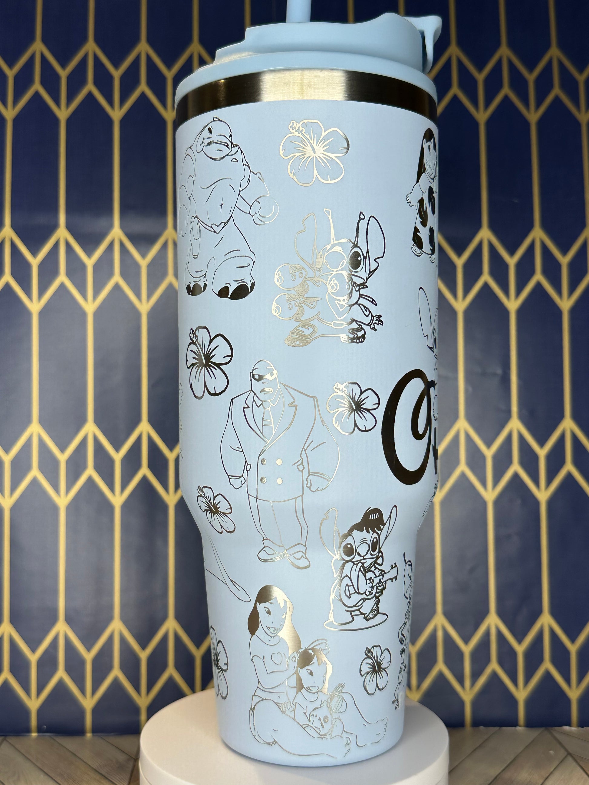 a white coffee cup with black and gold designs on it