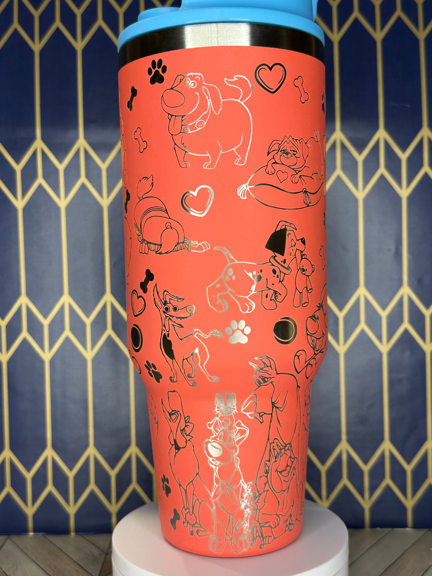 a red cup with drawings on it sitting on a wall