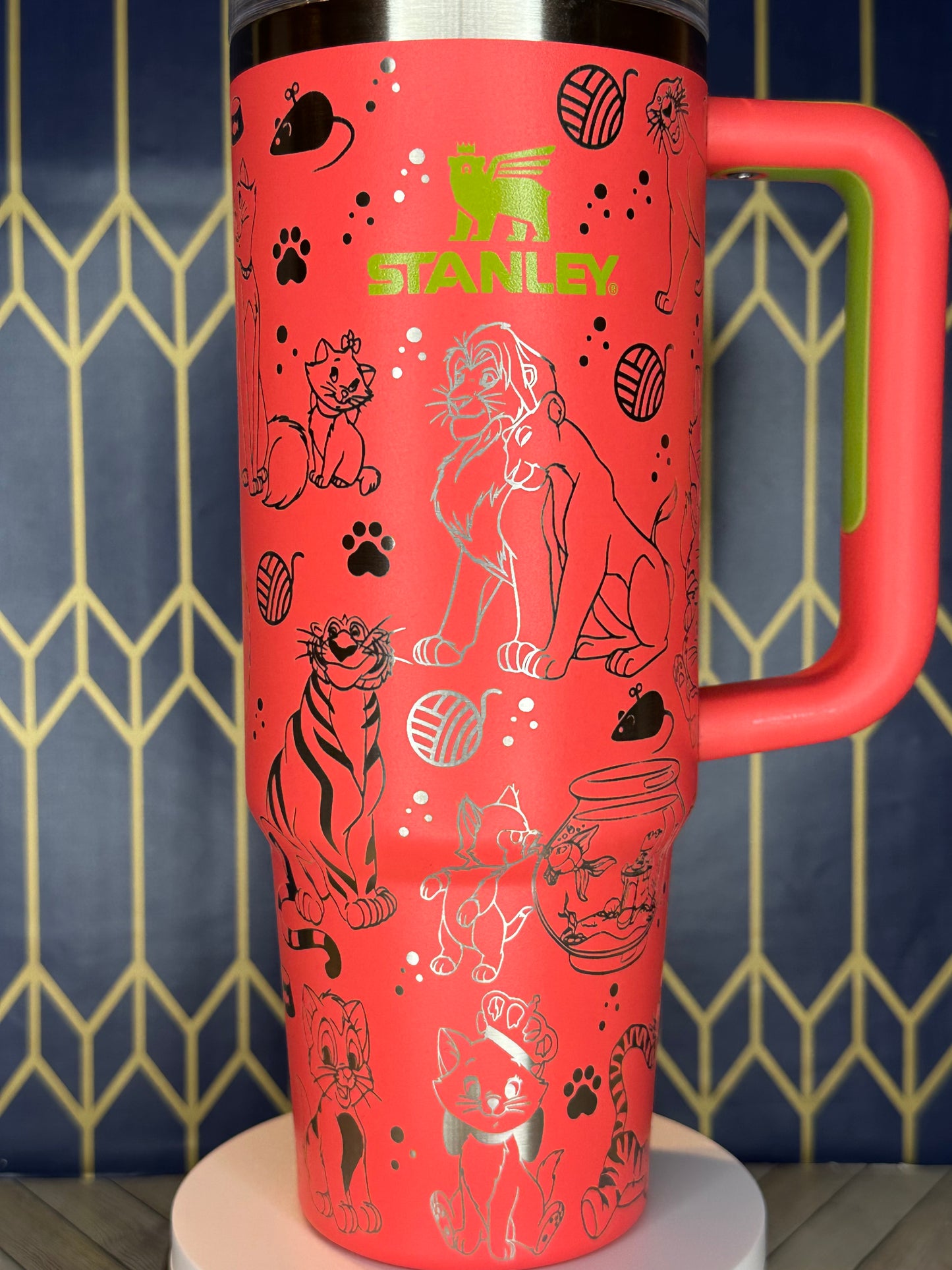 a red cup with a handle and a pattern on it