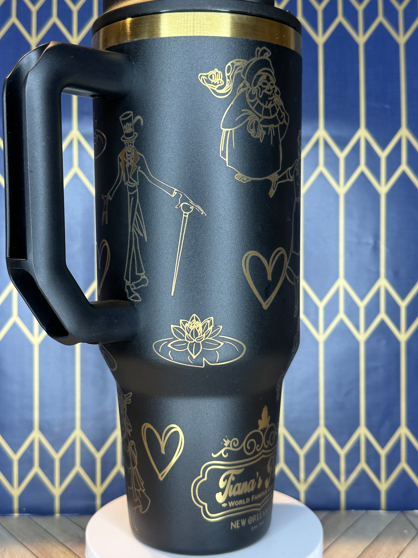 a close up of a black and gold coffee cup