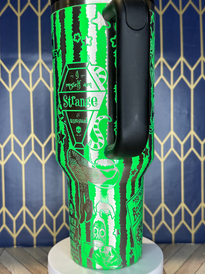 a close up of a green and black bottle on a wall