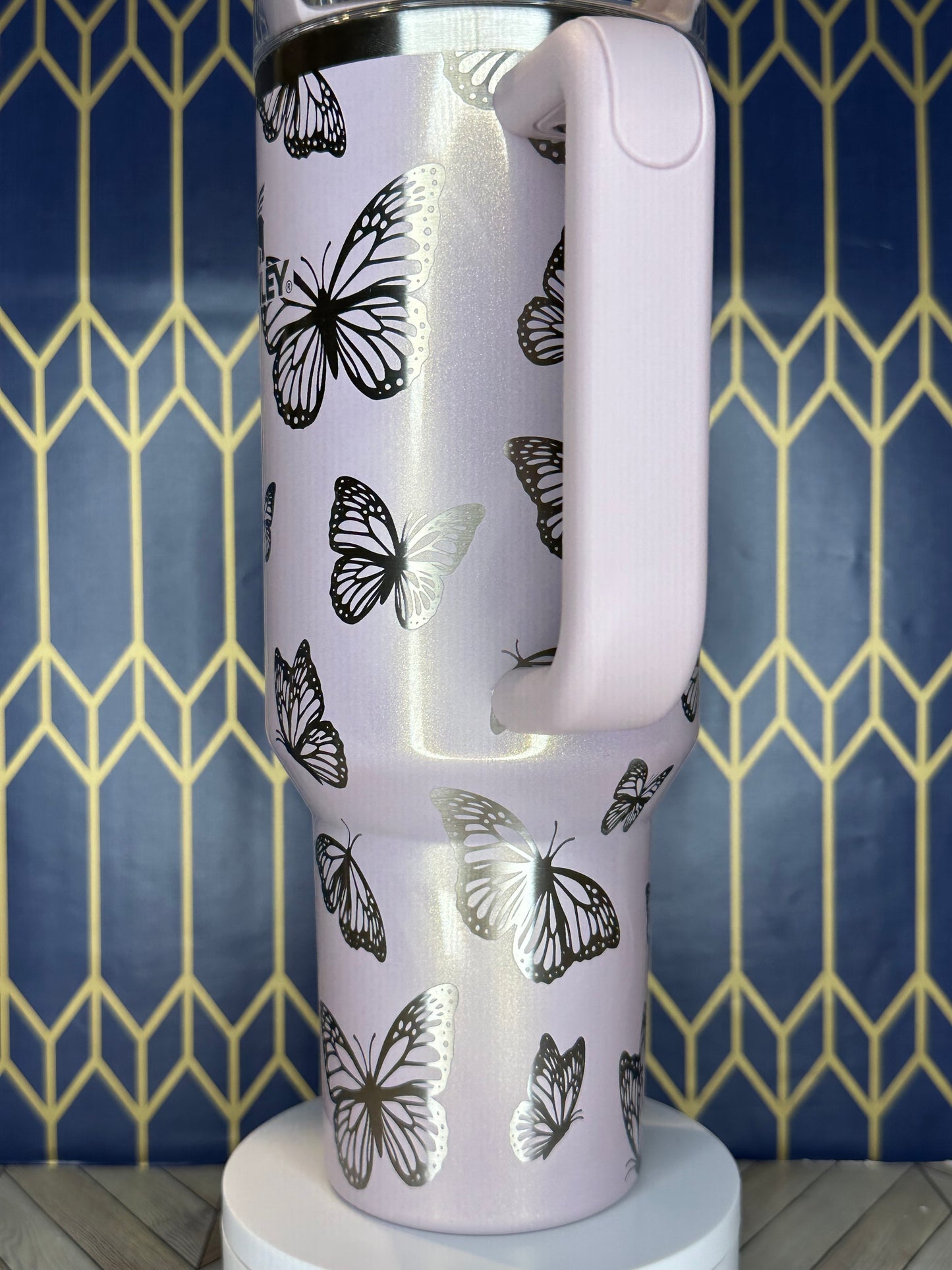 a close up of a toilet with a butterfly pattern on it