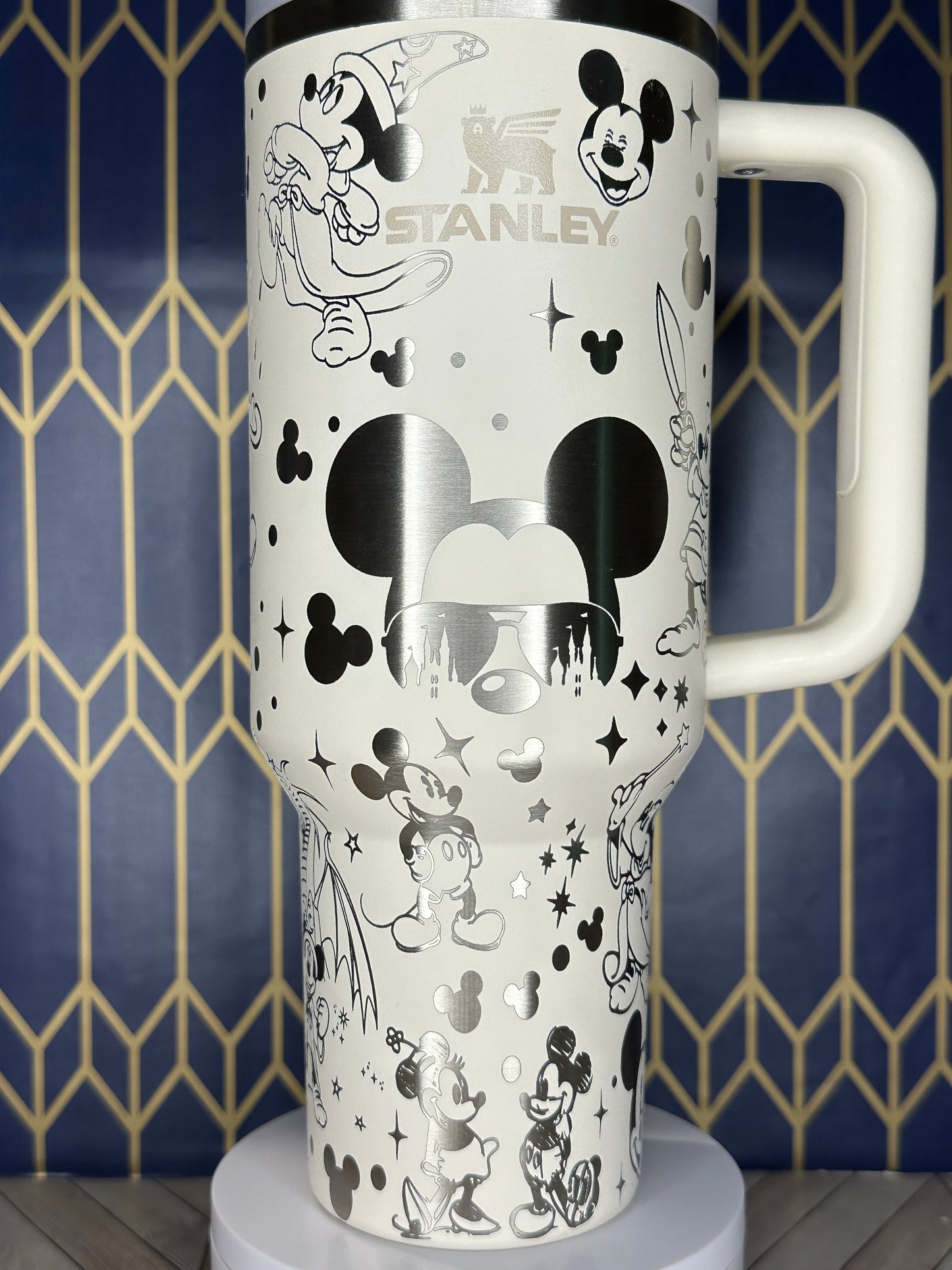 a white and black mickey mouse travel mug