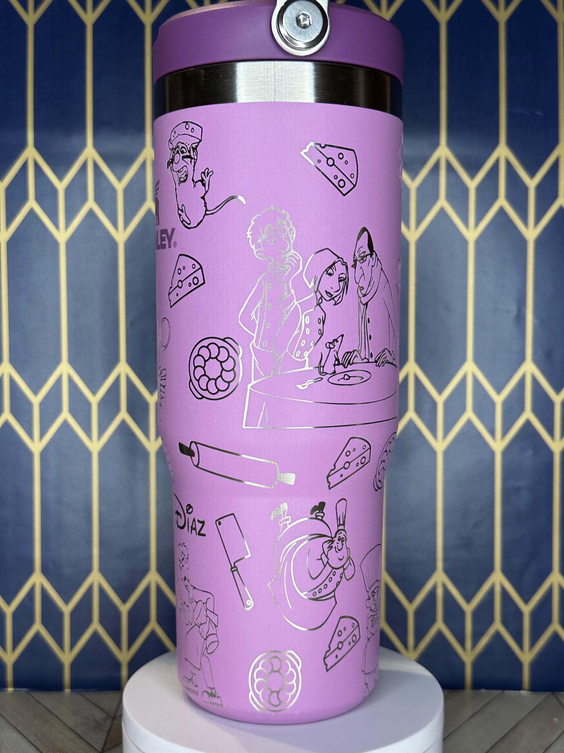 a purple coffee cup with drawings on it