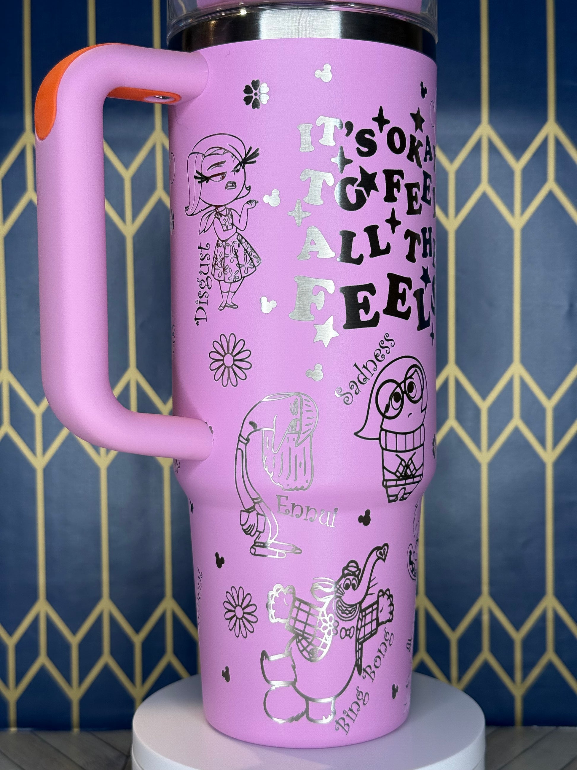 a close up of a pink water bottle on a wall