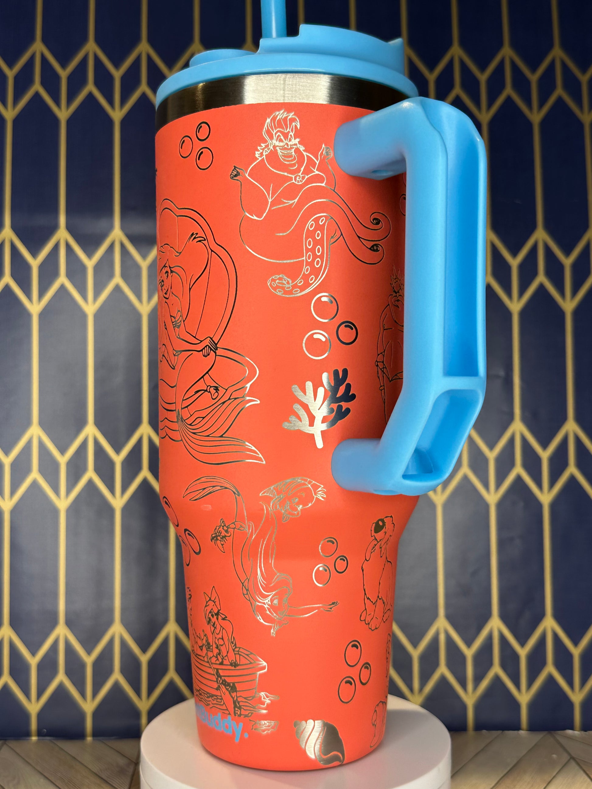 a red cup with a blue handle on a wall