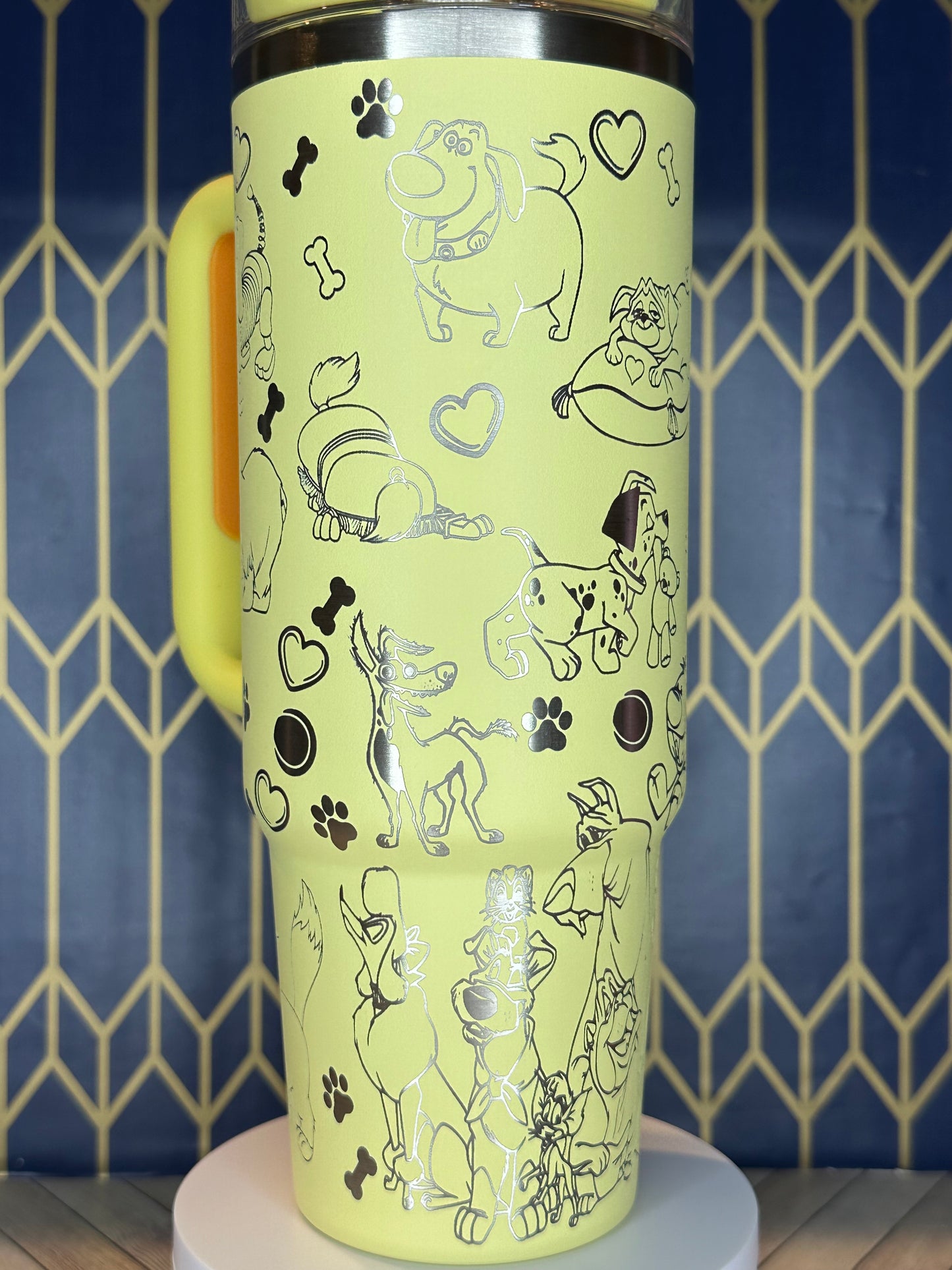 a close up of a yellow cup with drawings on it