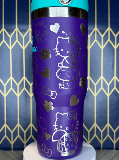 a purple cup with hello kitty designs on it