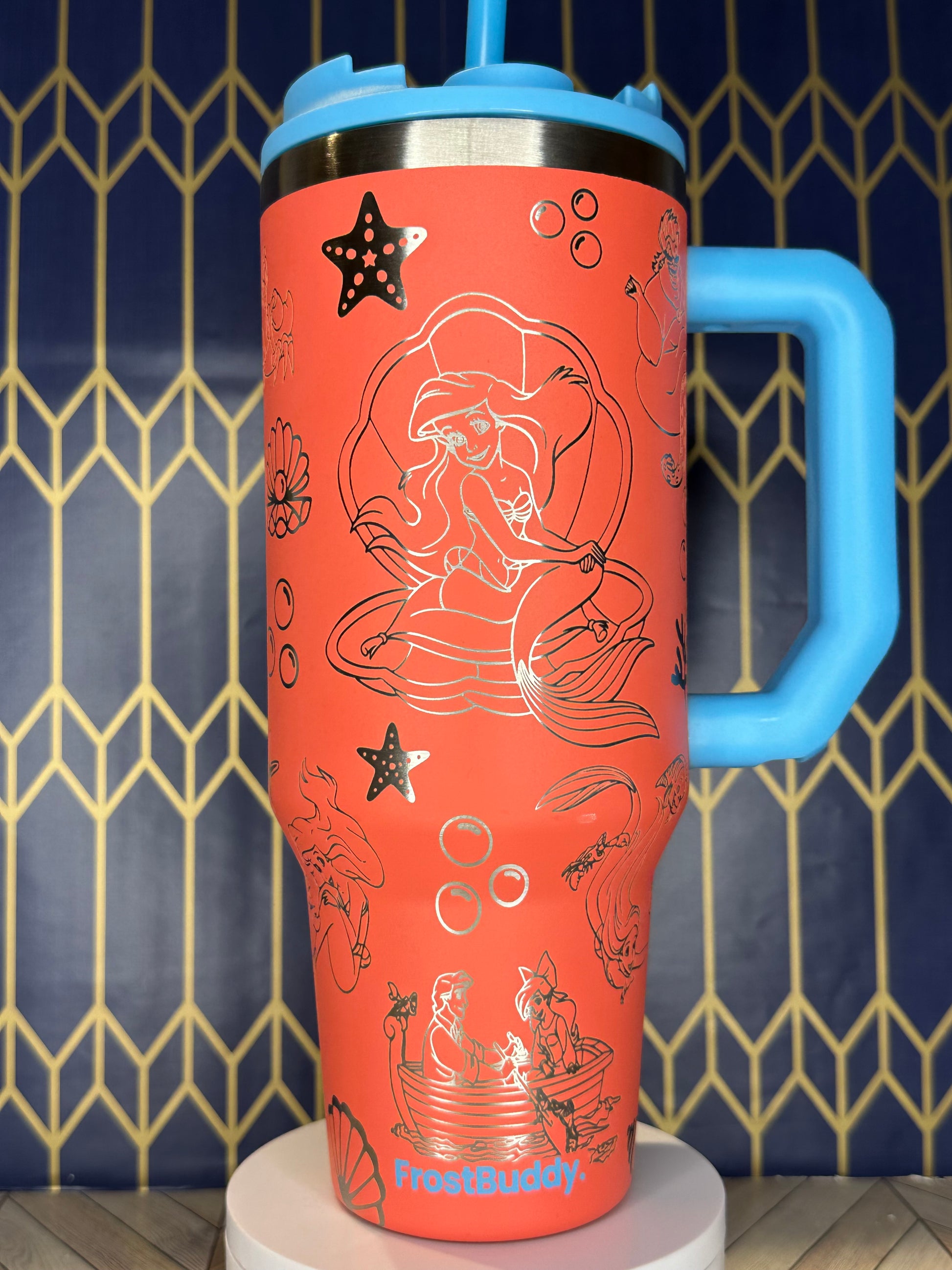 a red cup with drawings on it on a wall