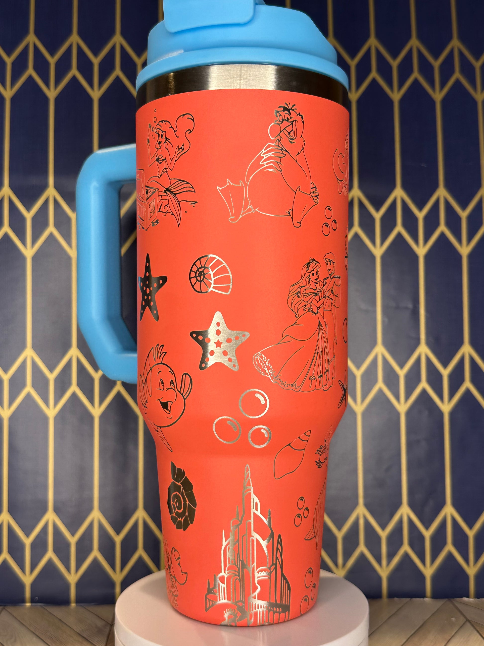 a red and blue cup with drawings on it