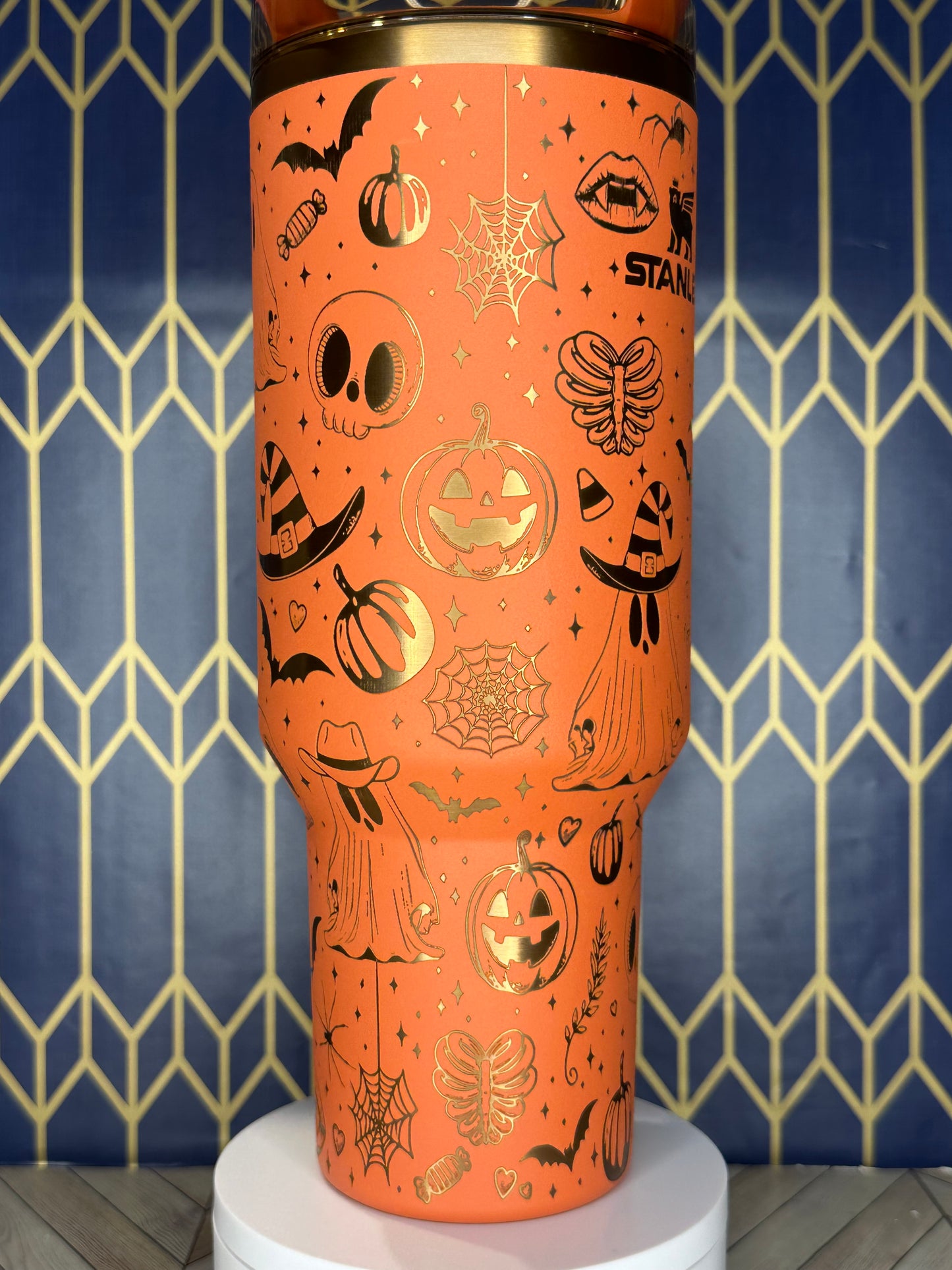 a close up of an orange vase on a wall